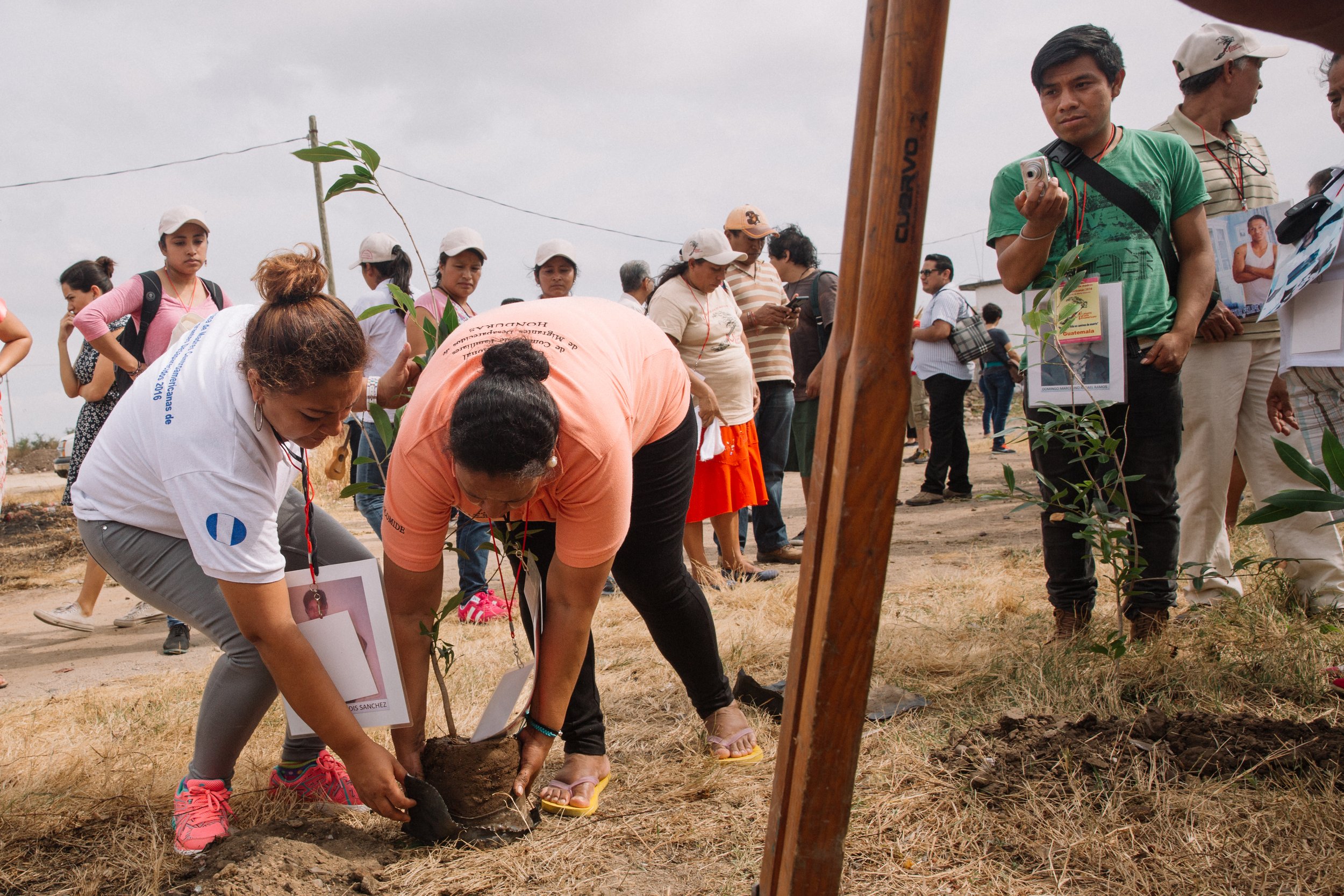  Two grieving mothers find solace in a symbolic act of remembrance, as they plant a tree in the section of the cemetery where a mass grave of unidentified migrant bodies is buried. Their hearts heavy with sorrow, the women honor the memory of those w