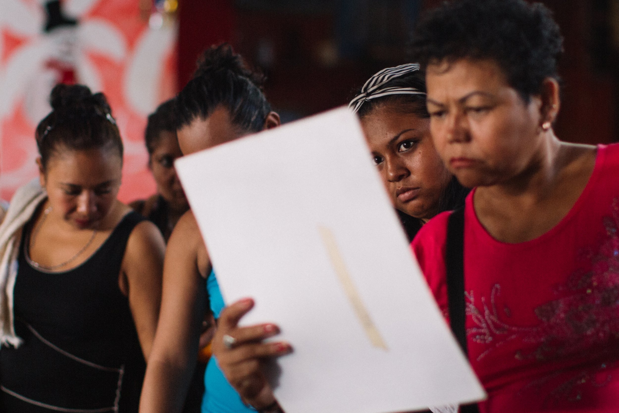  At a popular strip club called El Marinero in Tapachula, Chiapas, Mexico, workers look through photos of their missing loved ones in Tapachula, Chiapas, Mexico. The mothers understand the realities of the migrant journey and the risks that many wome