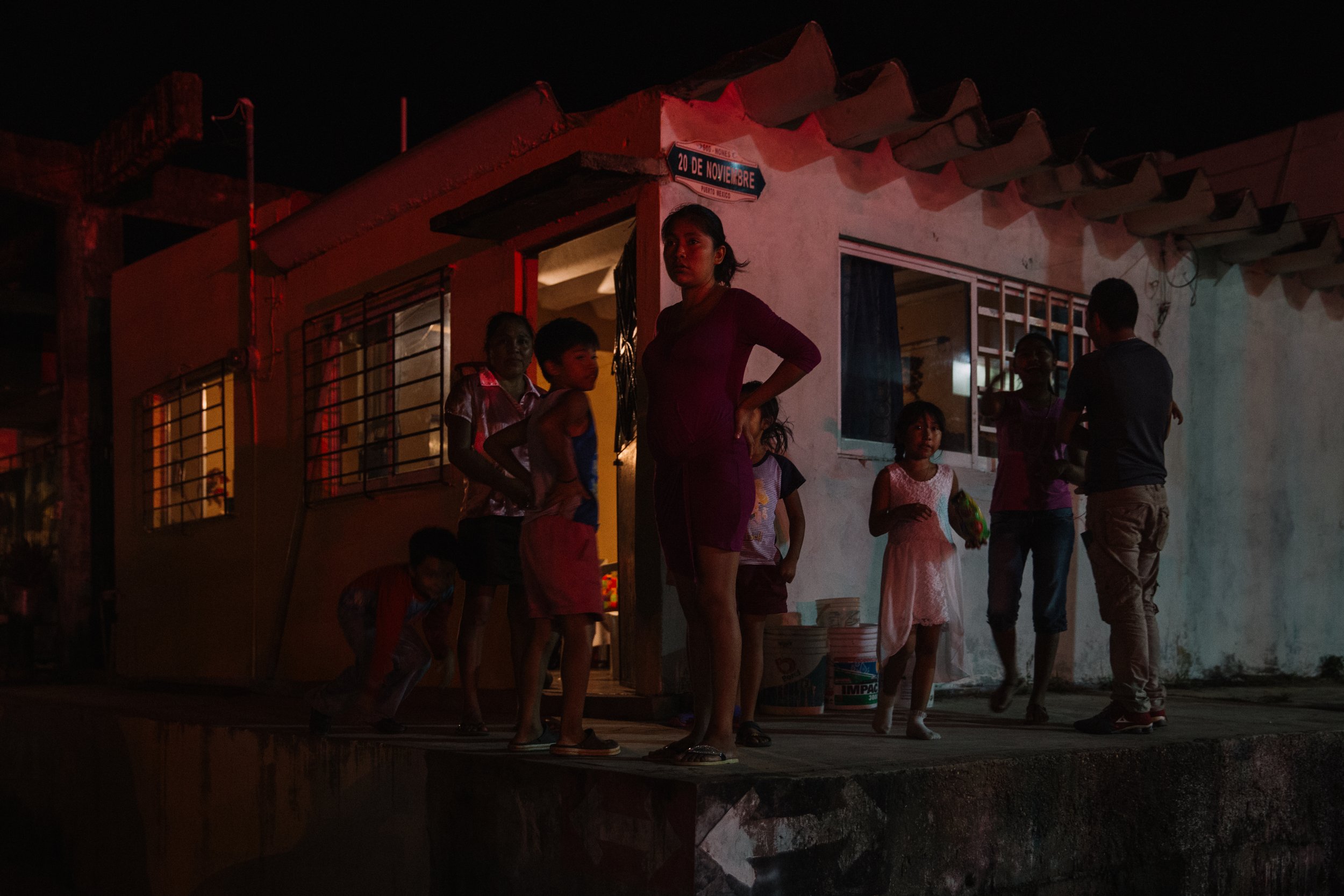  As night falls in Coatzacoalcos, Veracruz on November 18, 2016, a group of mothers take to the streets to call attention to the epidemic of disappearances in Mexico. Neighbors gather to watch and show support for the women, who have been searching f