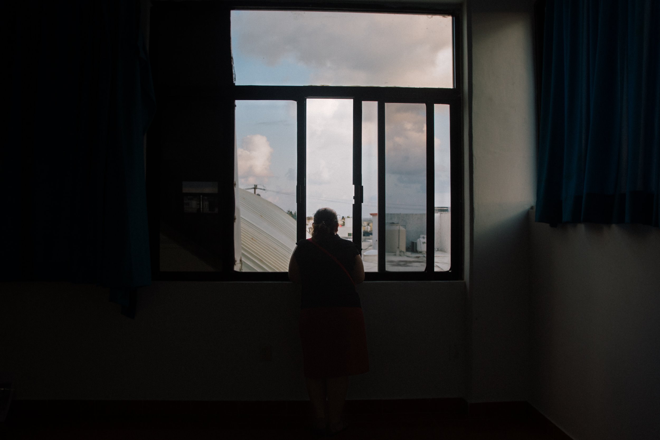  Anita Celaya, a member of the Caravana de Madres de Migrantes Desaparecidos from El Salvador, takes a moment to herself to watch the sunrise over the shore in Coatzacoalcos, Veracruz, Mexico. 