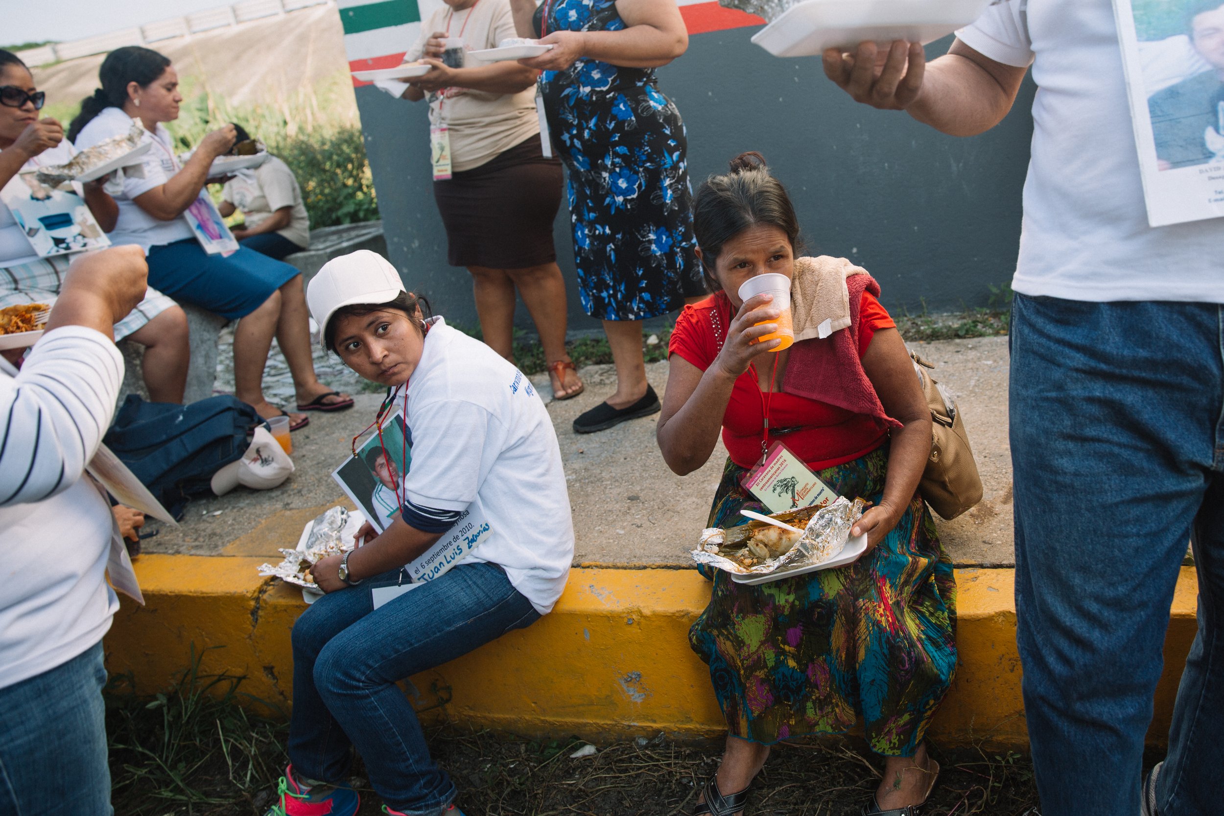  Mothers of the migrant caravan gather to share a meal during a quick pitstop on their journey to Coatzacoalcos, Veracruz, Mexico. 