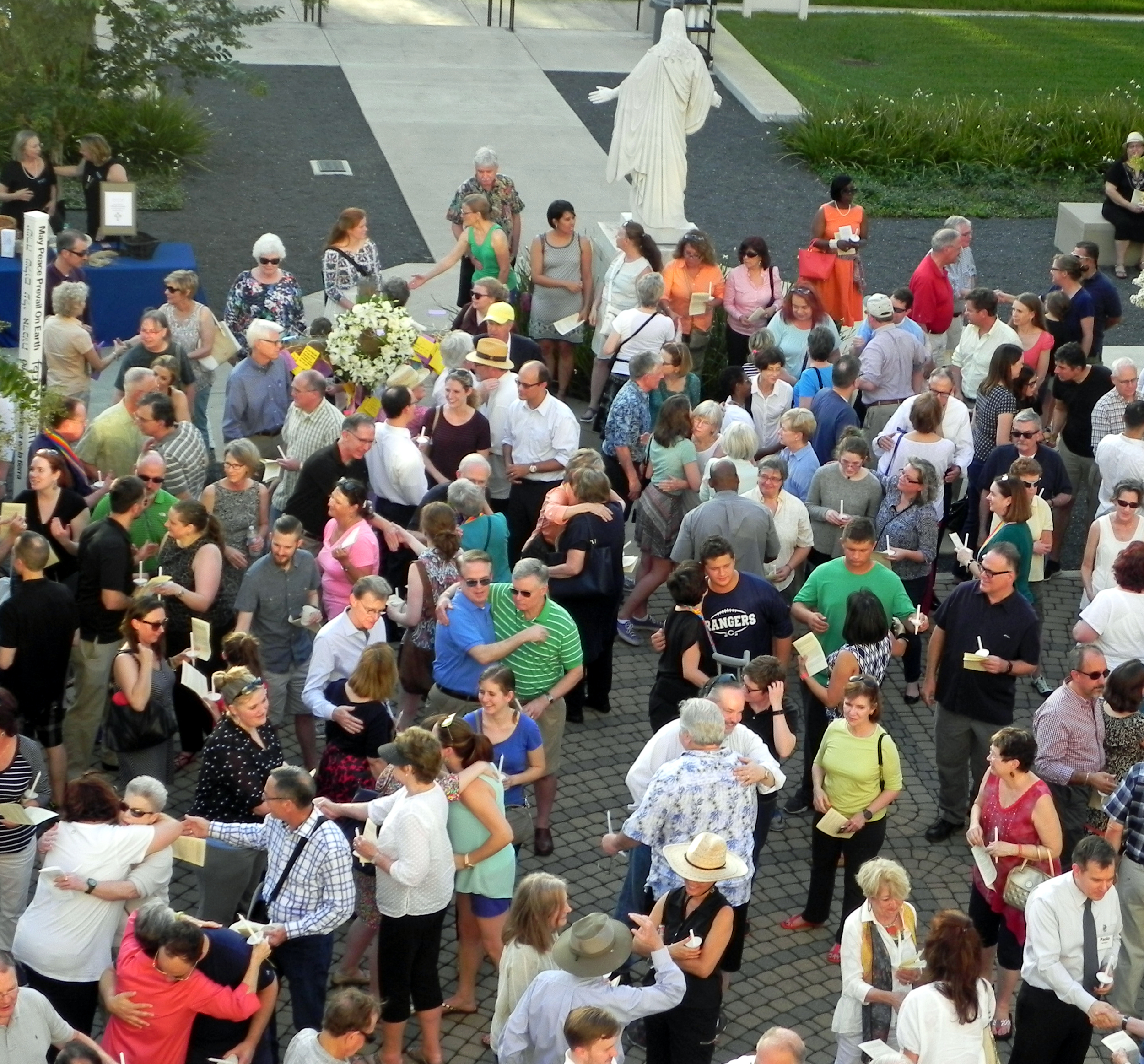 Behind the outstretched, welcoming arms of Jesus, worshipers of many congregations pass the peace at the June 15 Prayer Vigil of Lament and Hope on St. Paul's Labyrinth.