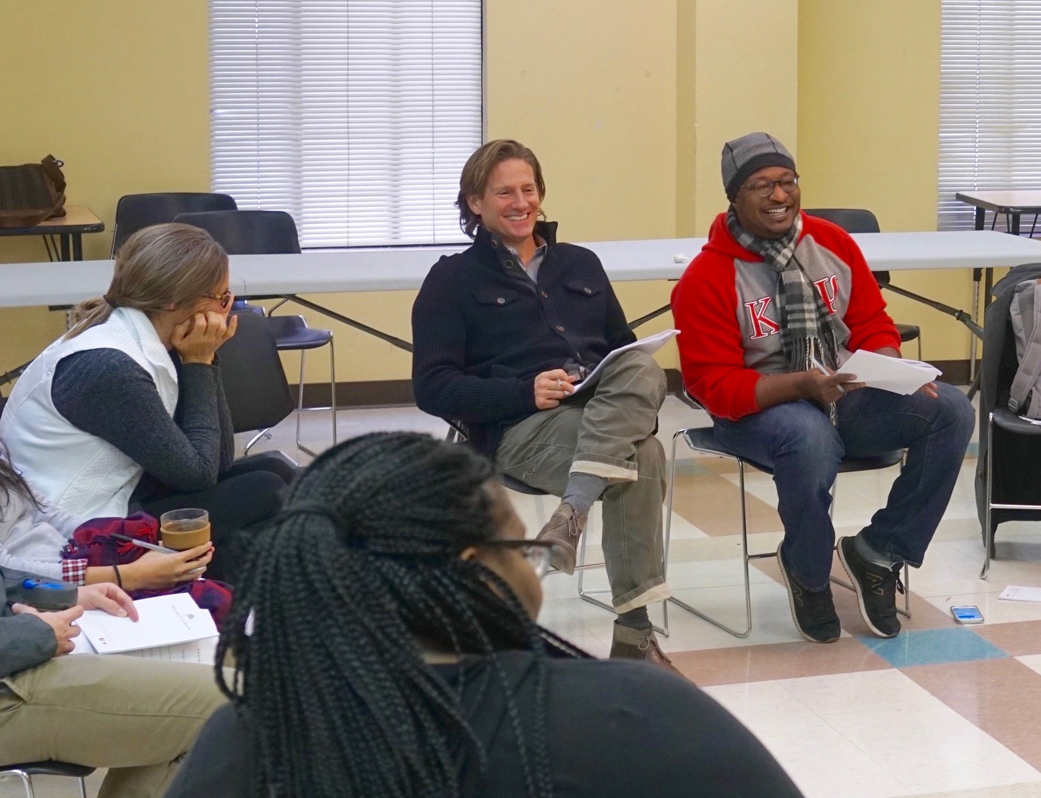 Cleve Tinsley (with hat and scarf) and Matt Russell (at center) lead group discussion