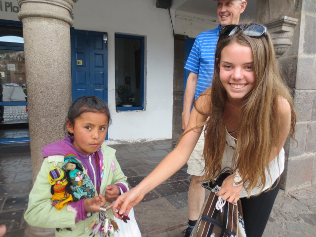 Dora buying lama keychains from a beautiful little girl