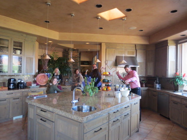 Benedikt opening champagne in the kitchen