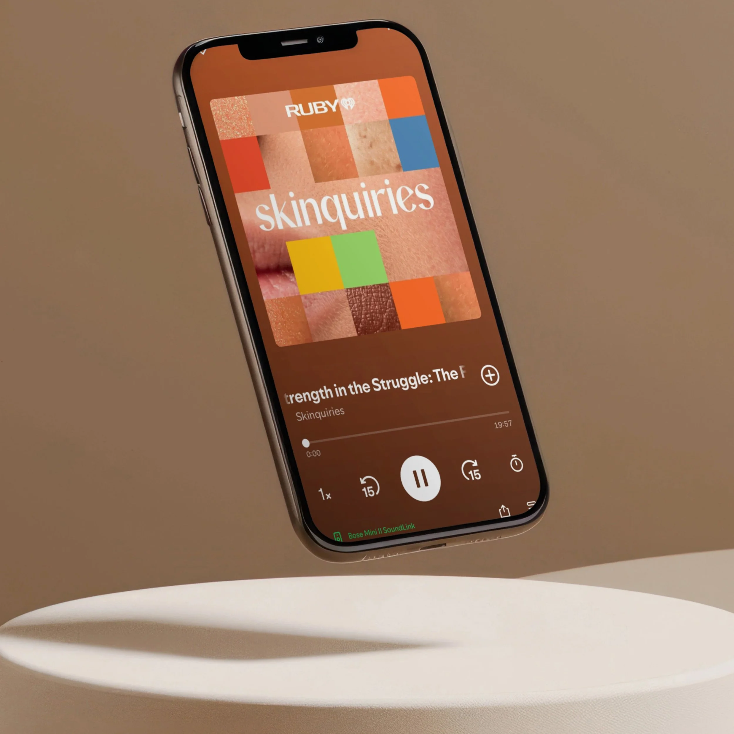 skinquiries ruby podcast cover, shown on iphone floating in air above a platform