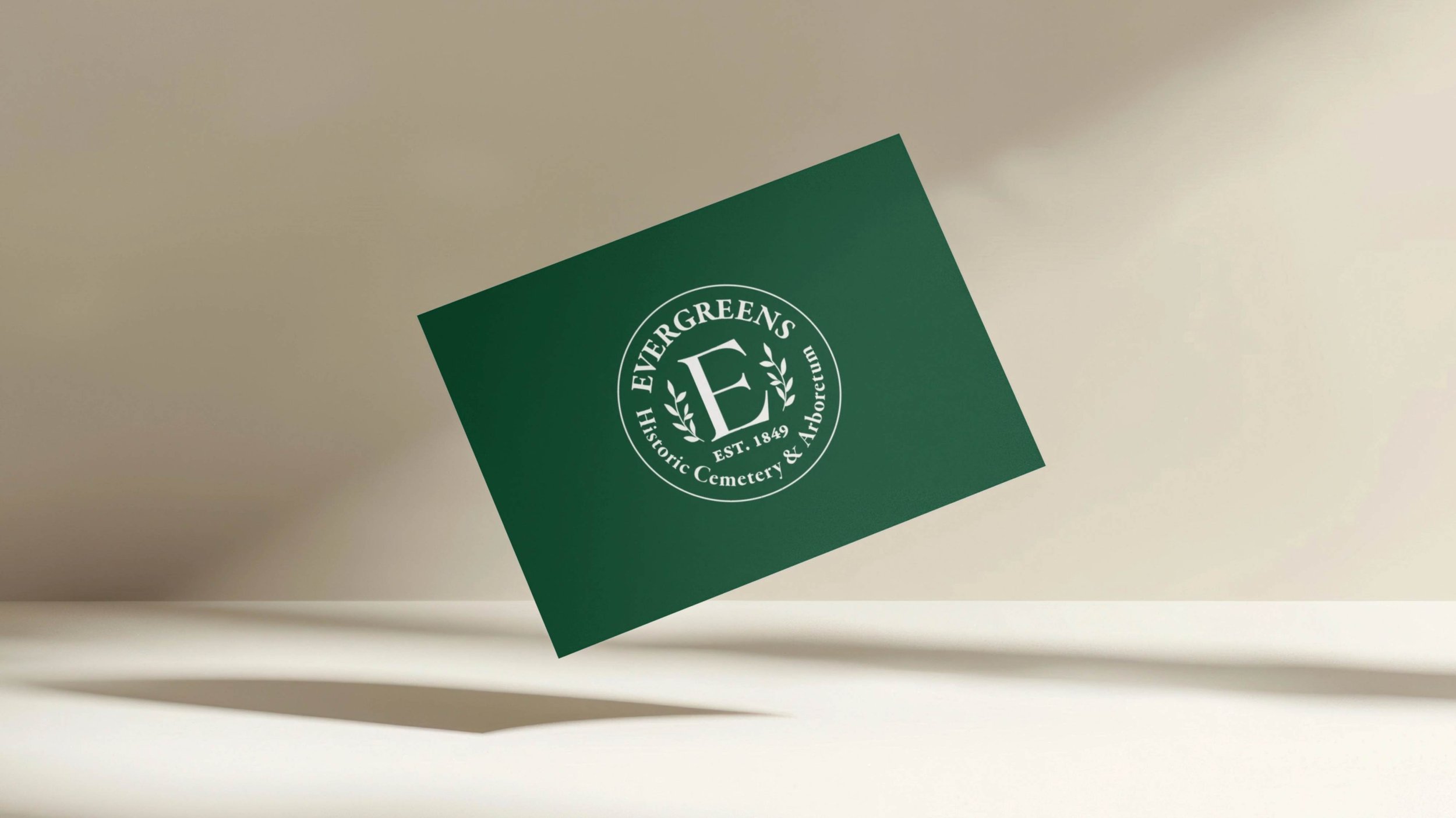 Evergreens cemetery business card floating on shadowed background