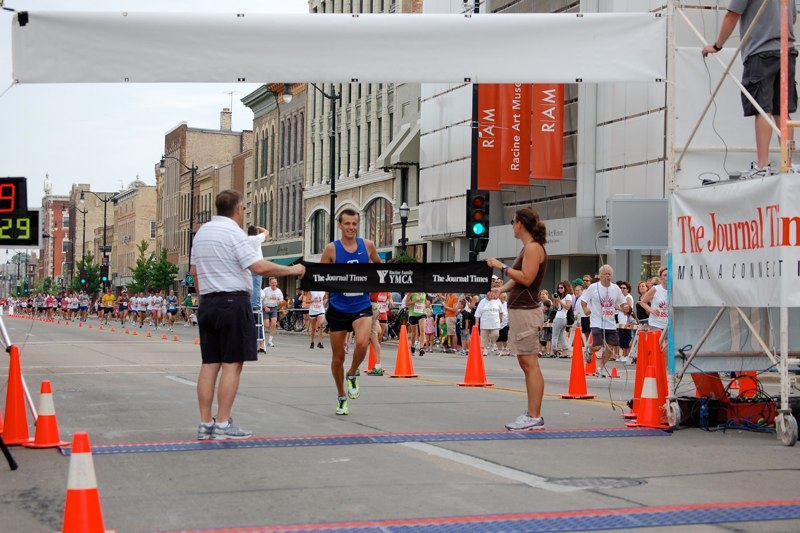 2012 winner crossing the finish line in Downtown Racine. Photo courtesy of lighthouserun.com.