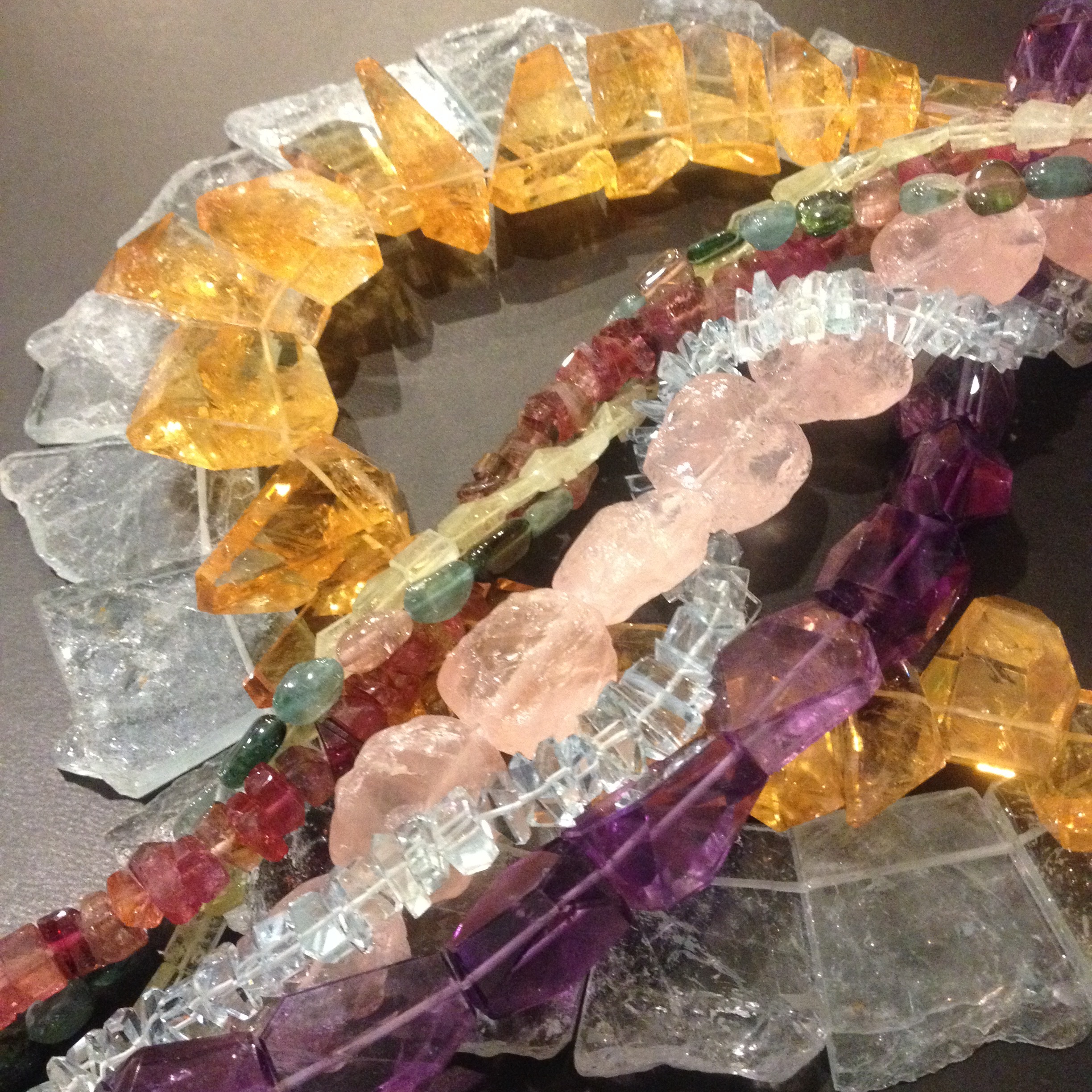 A quick peek of Robert Bentley's work that will be featured on First Friday. Pictured: Blue Topaz, Citrine, Tourmaline, Grossolar Garnet, Multi-Tourmaline, Rose Quartz, Aquamarine, and Amethyst.