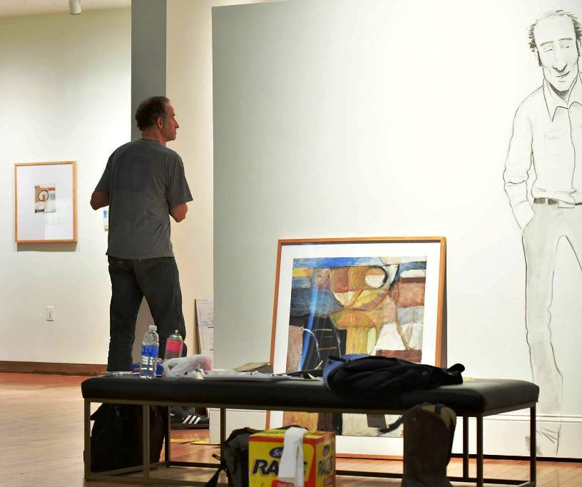 Diffee working with HMA staff on setting up for his HMA show, including drawing himself on the gallery walls.(Photo Jason Overb.)