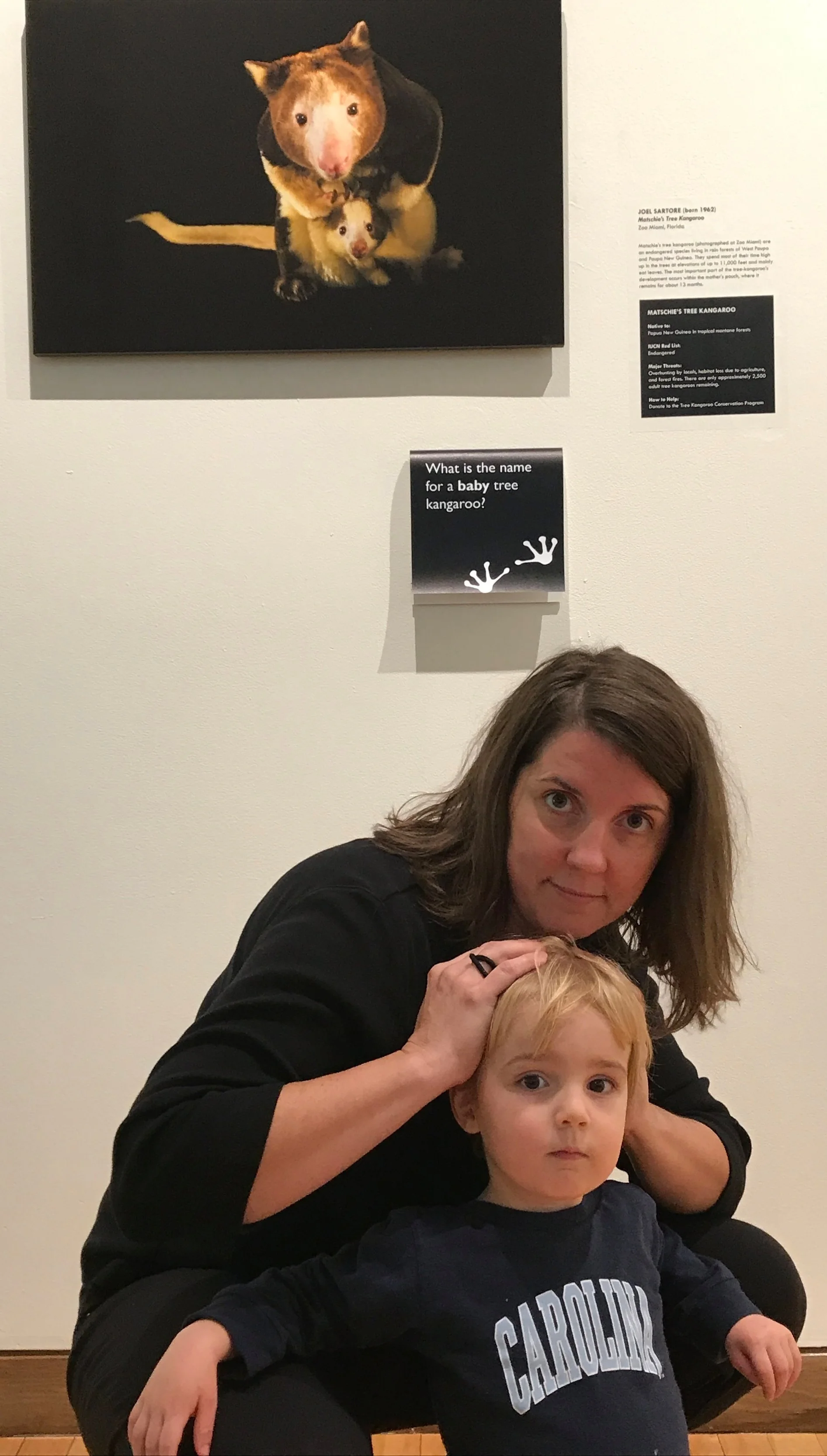 Kristina with her son Knox posing as Joel Sartore’s photograph of Matchie’s Tree Kangaroos.