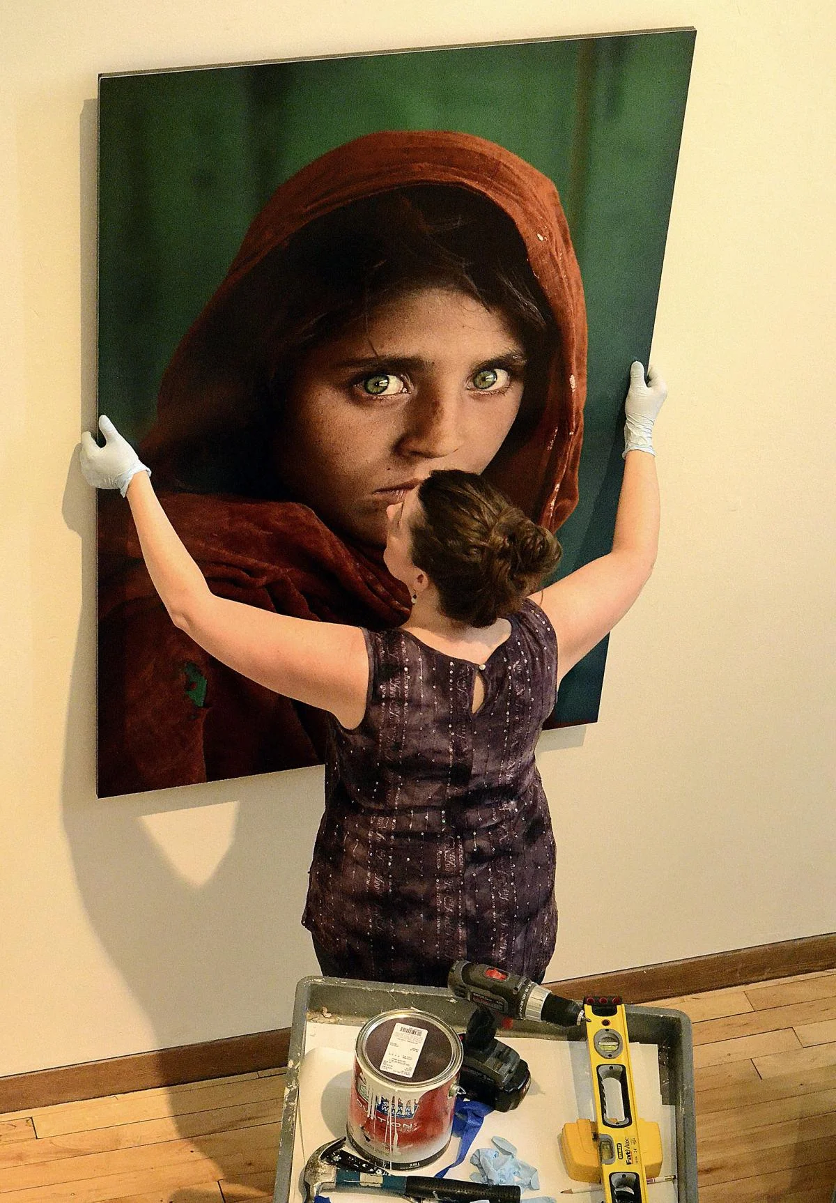 Kristina hanging Steve McCurry’s Afghan Girl. Photo by Robert Reed.