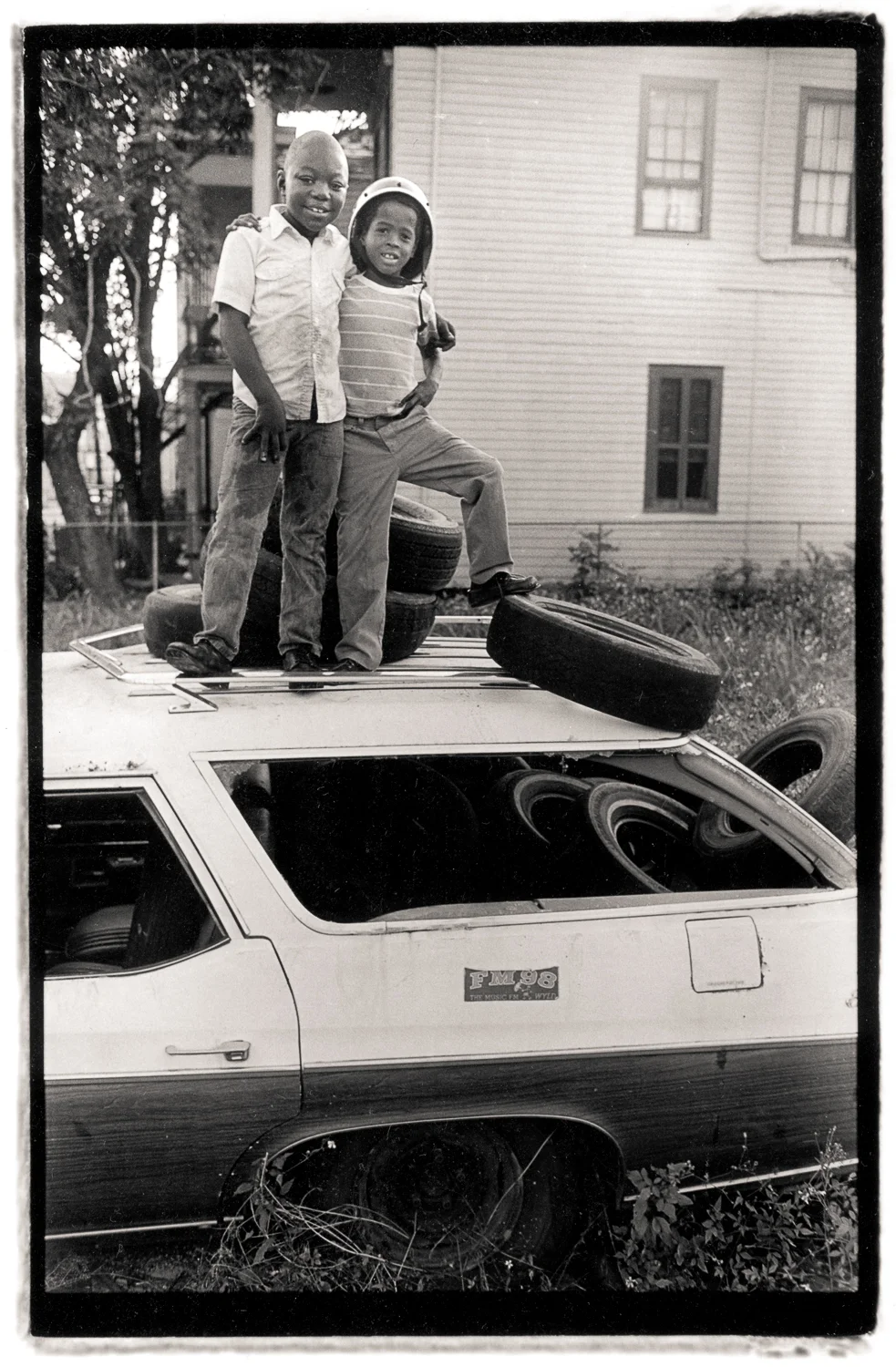 Two kids on car in Central City New Orleans, LA 1987