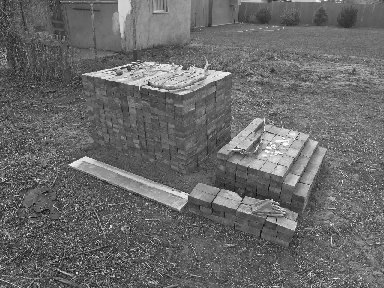 28-31 January 2014: Lynn and Rebecca managed to dig up these bricks with their hands, brushing them clean with leather gloves. All sorts of glass/remnants of glassware lay buried here, we think, used to be a pharmacy or mechanics shop. We stacked the bricks in fourteen rows, Josh made the joke, it is a brick sonnet, or an ode to Carl Andre.