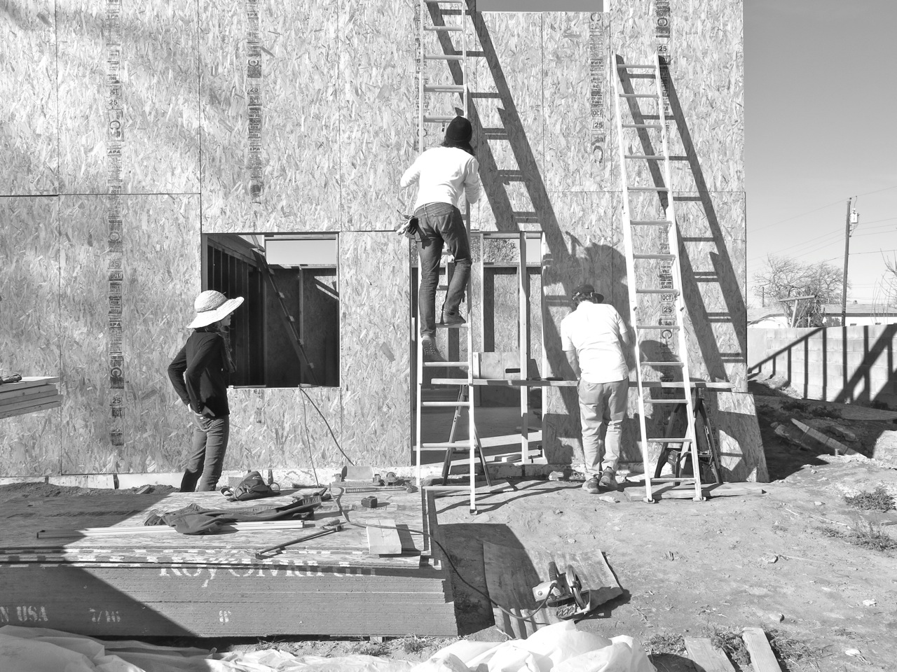 6 January 2015: Lisa and Brandon drove in last night -- here they are helping us with the final sheets of sheathing.