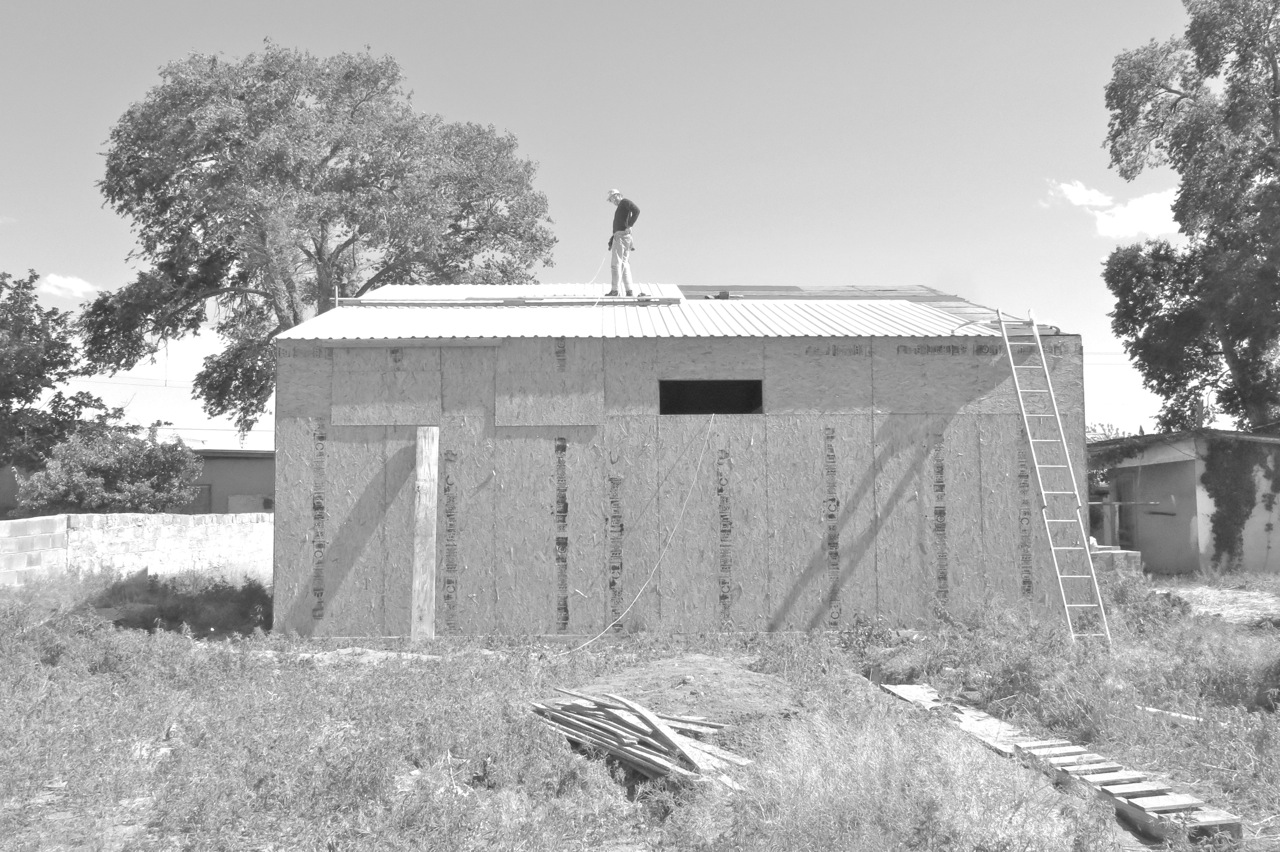 6 May 2015: After a few months loitering below the equator, the Tyvek is gone and spring winds blew off most of the Roofing felt. But we're back at it, and here's Josh nailing down our galvalume (aluminum-zinc alloy coated steel), which will hopefully outlast our human life.