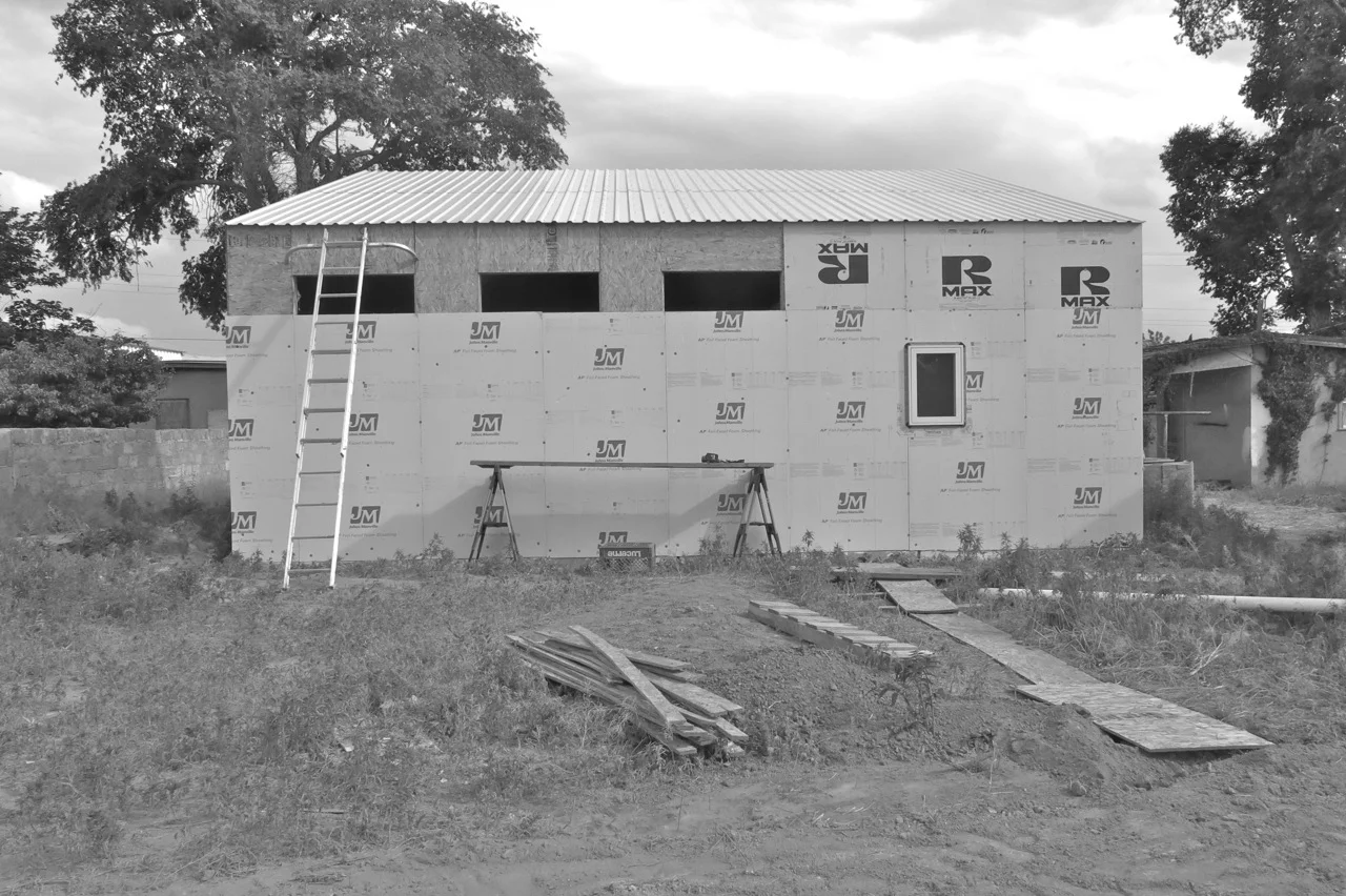 8 May 2015: The roof is up, and here you can see most of the R-panel/rigid insulation is in place.