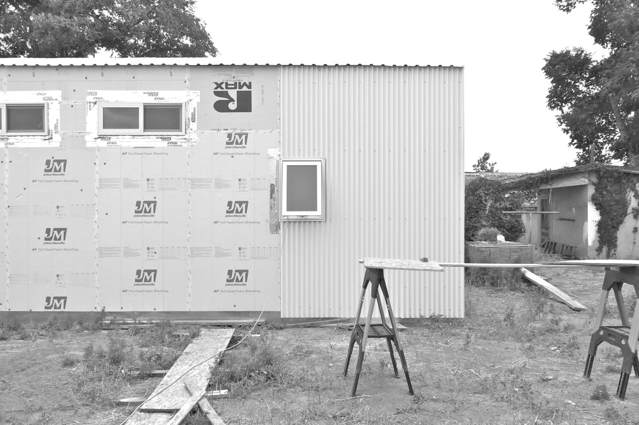 21 May 2015: Three panels of siding on the north wall.