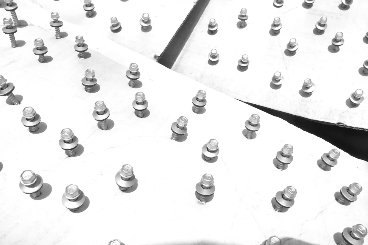 28 May 2015: Ran out of white screws for our siding. Neither McCoy's in Alpine nor Marfa Hardware had white screws, so we purchased silver screws, pinched them in cardboard, shook the can, and sprayed them white.