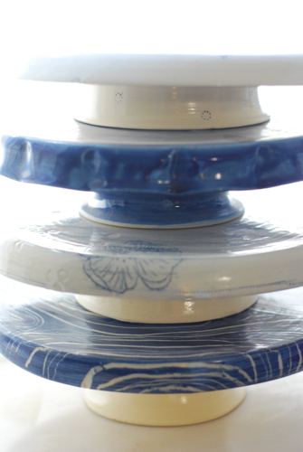 a mix of blue and white cake plates, both contemporary and traditional