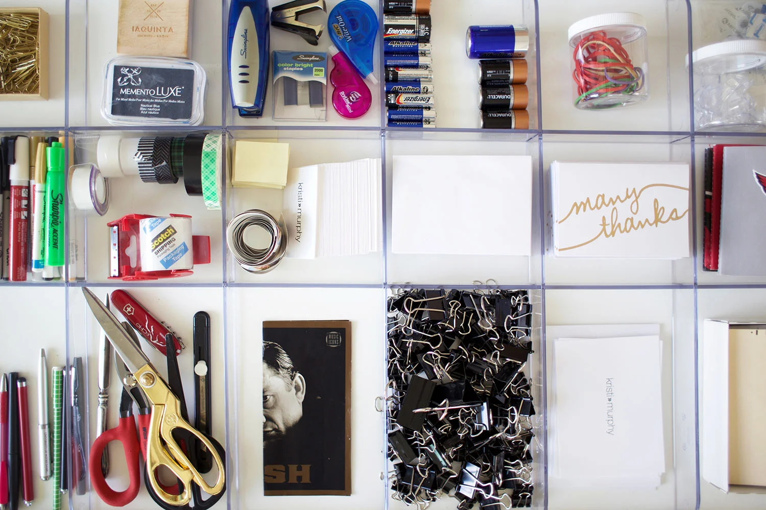 organized office supplies in a pull-out tray with dividers