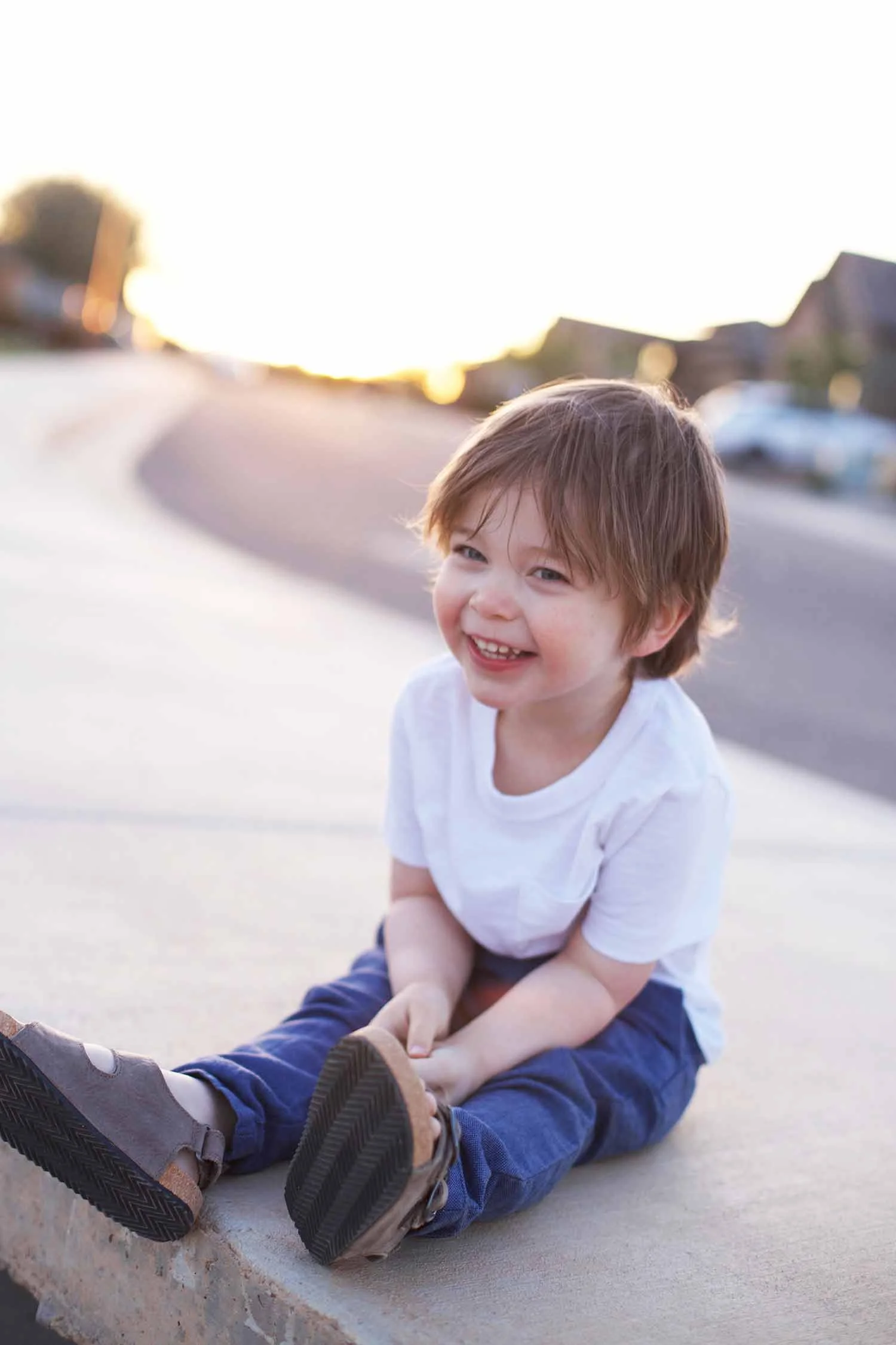 Easter picnic boy sitting on sidewalk
