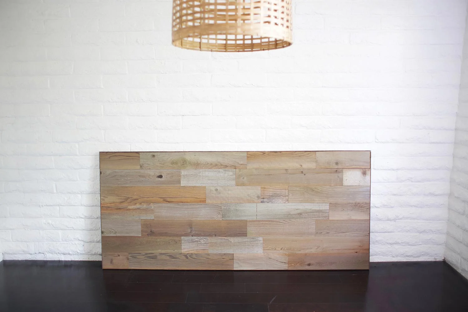 DIY reclaimed wood headboard against wall