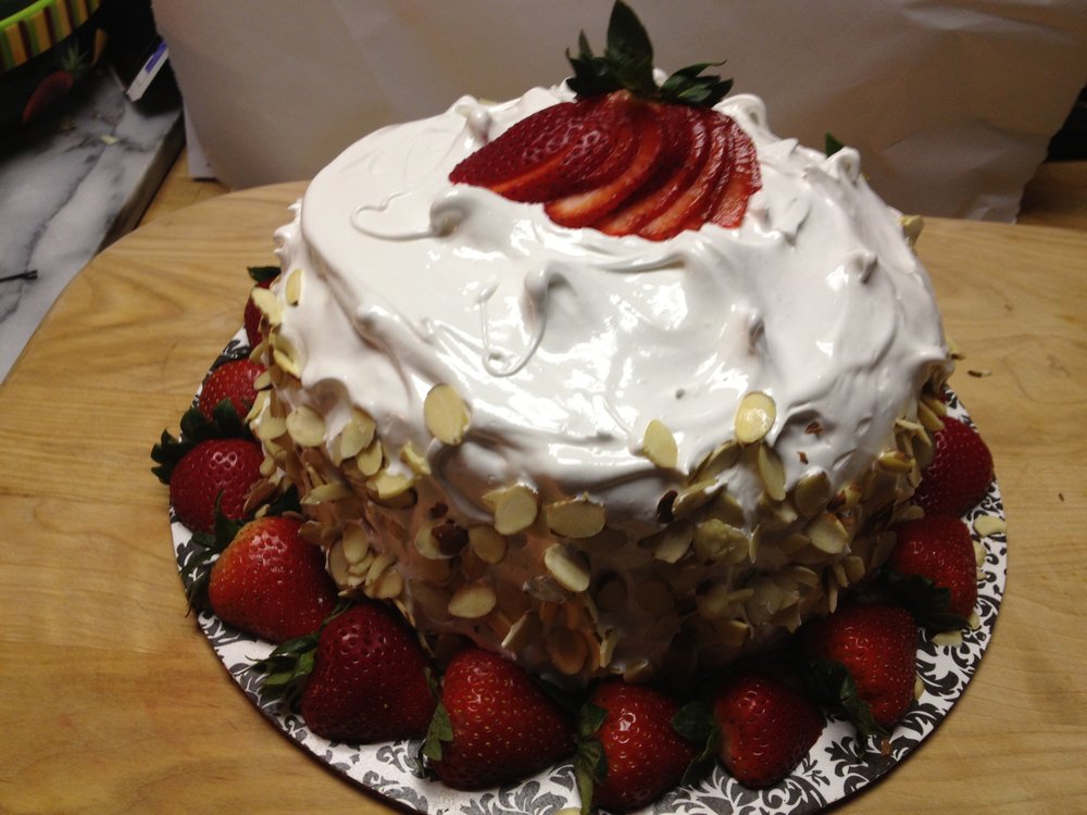 Coconut cake with 7 minute frosting and strawberries