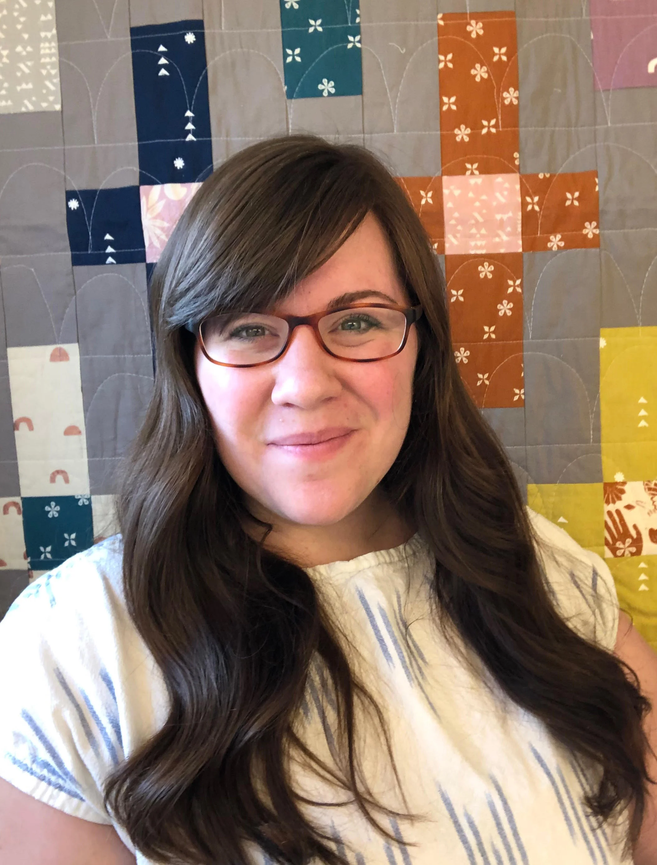 Kristin Rauch of Woolly Petals, in front of her new Moonrise quilt - pattern available in her Etsy shop