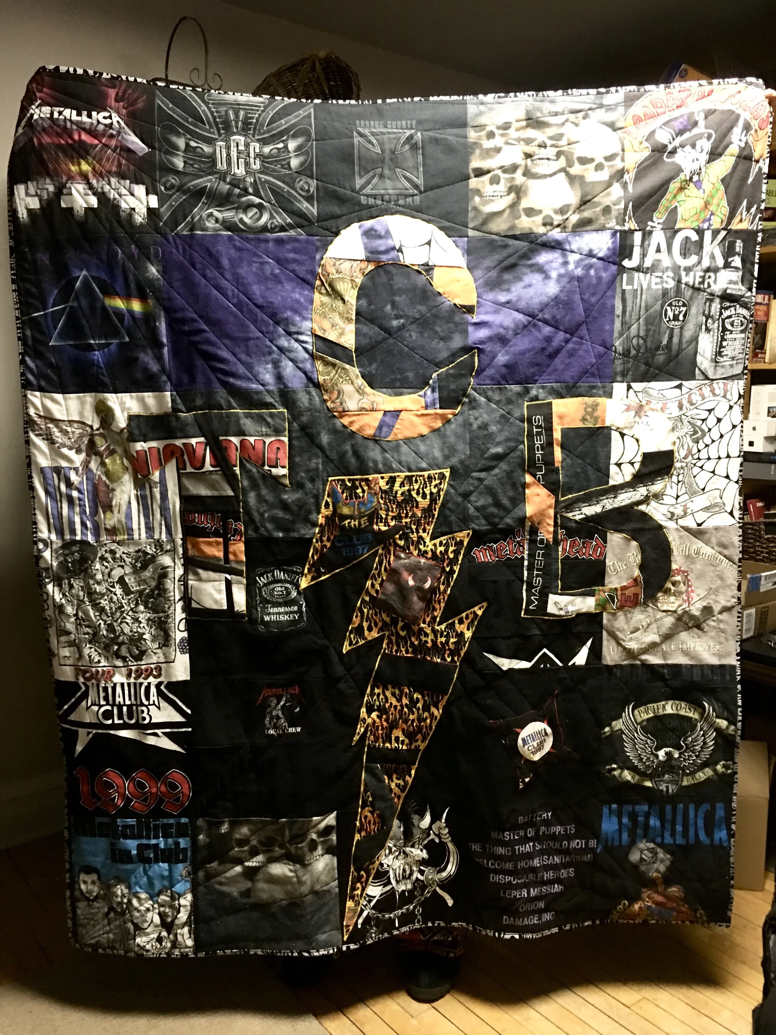 Metal Rock t-shirt quilt I made for my husband from his t-shirts and machine quilted with Christa’s radiating lines technique from her book Machine Quilting with Style