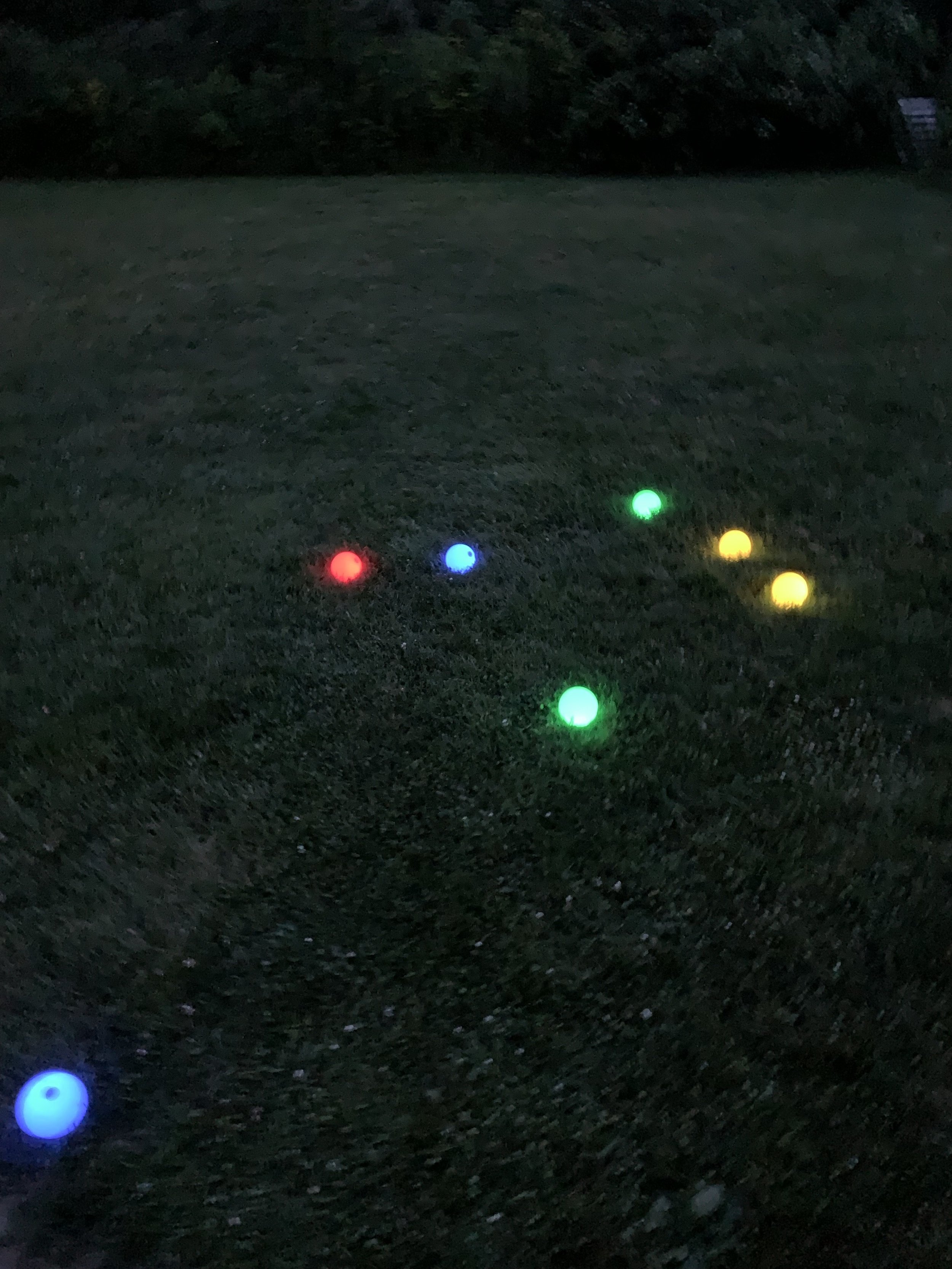 Lighted bocce balls in the dark