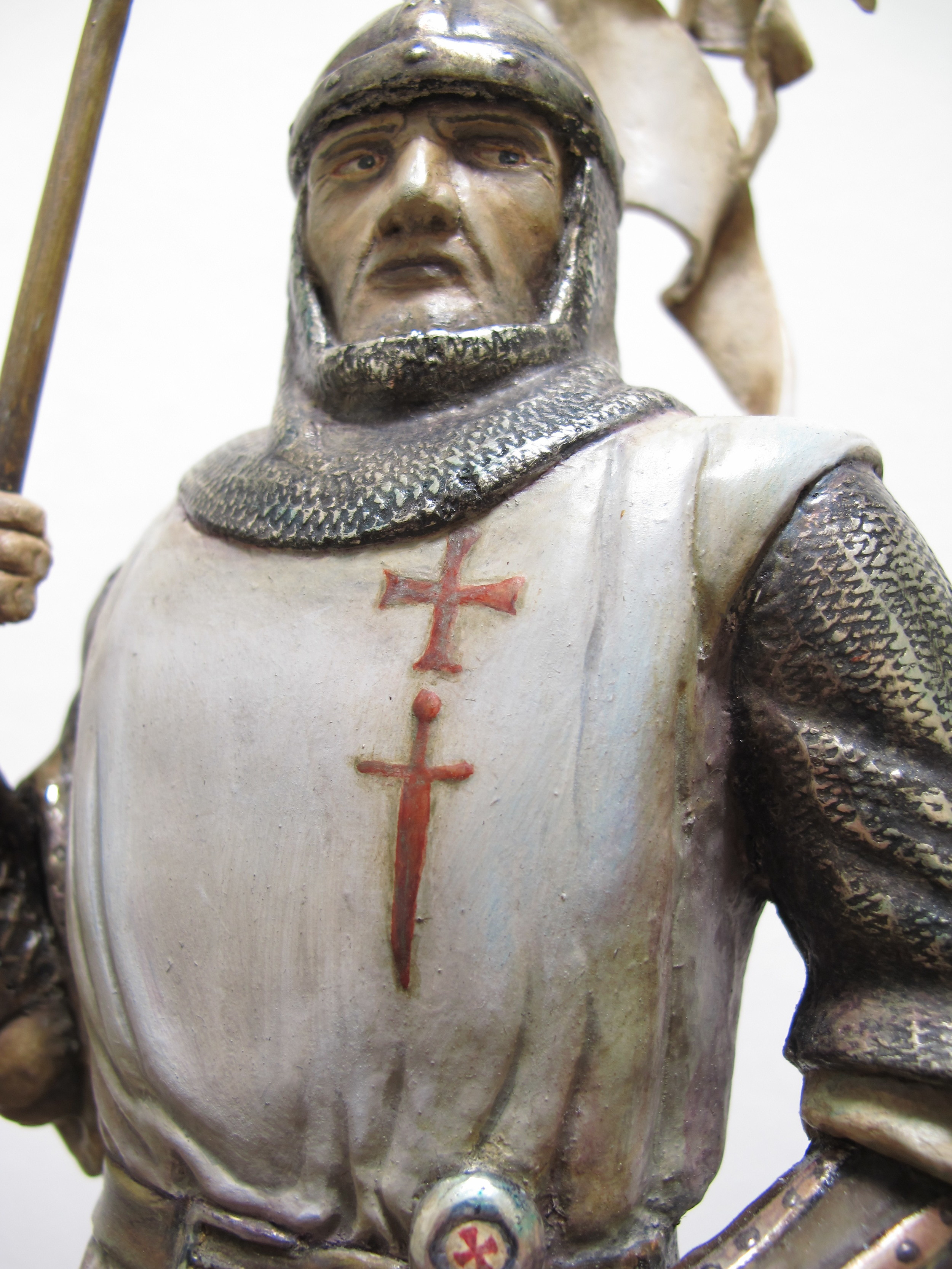This hand-carved knight represents the historic figure of a Teutonic Knight from the thirteenth century. The chain mail and all other metal details are gilded with white gold that has been varnished and patinated. Special care has been given to the painting of the face and the hands. 