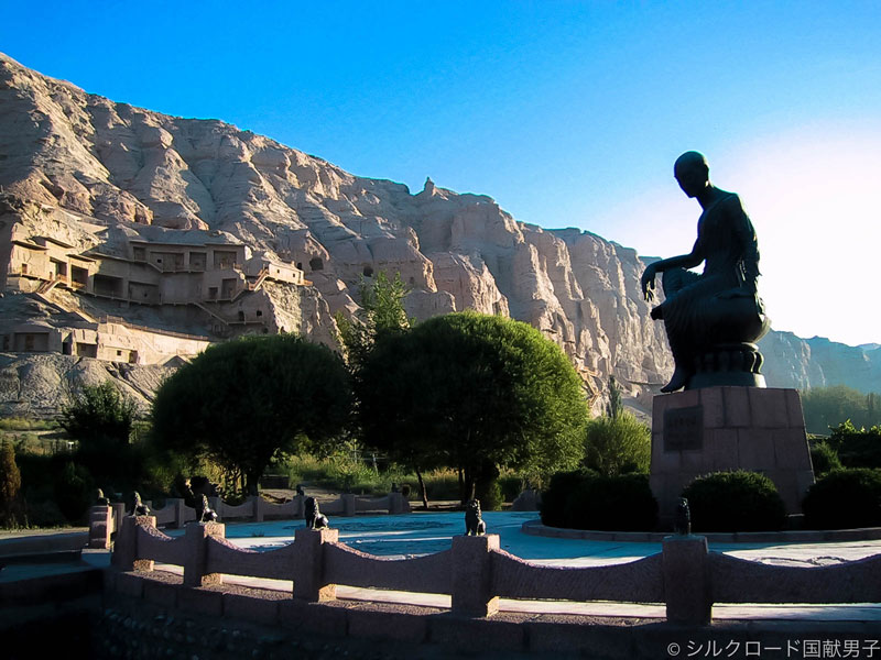 Kizil grottoes valley west view and statue of Rev Kumarajiva after restoration, 2003. Photo by Y. Kojima