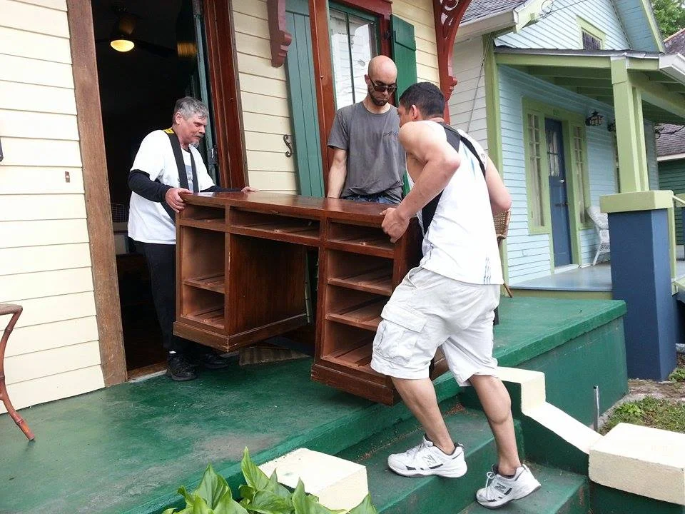 A heavy solid wood desk is made easier to move using a shoulder dolly.