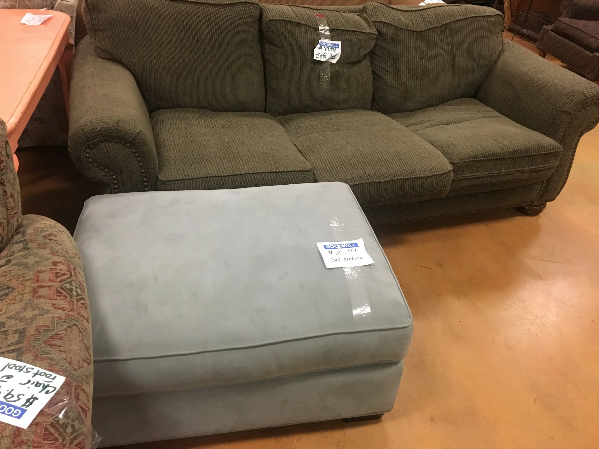 Ottoman at Goodwill with sofa sleeper in background that was delivered by MOVE IT! by bike earlier