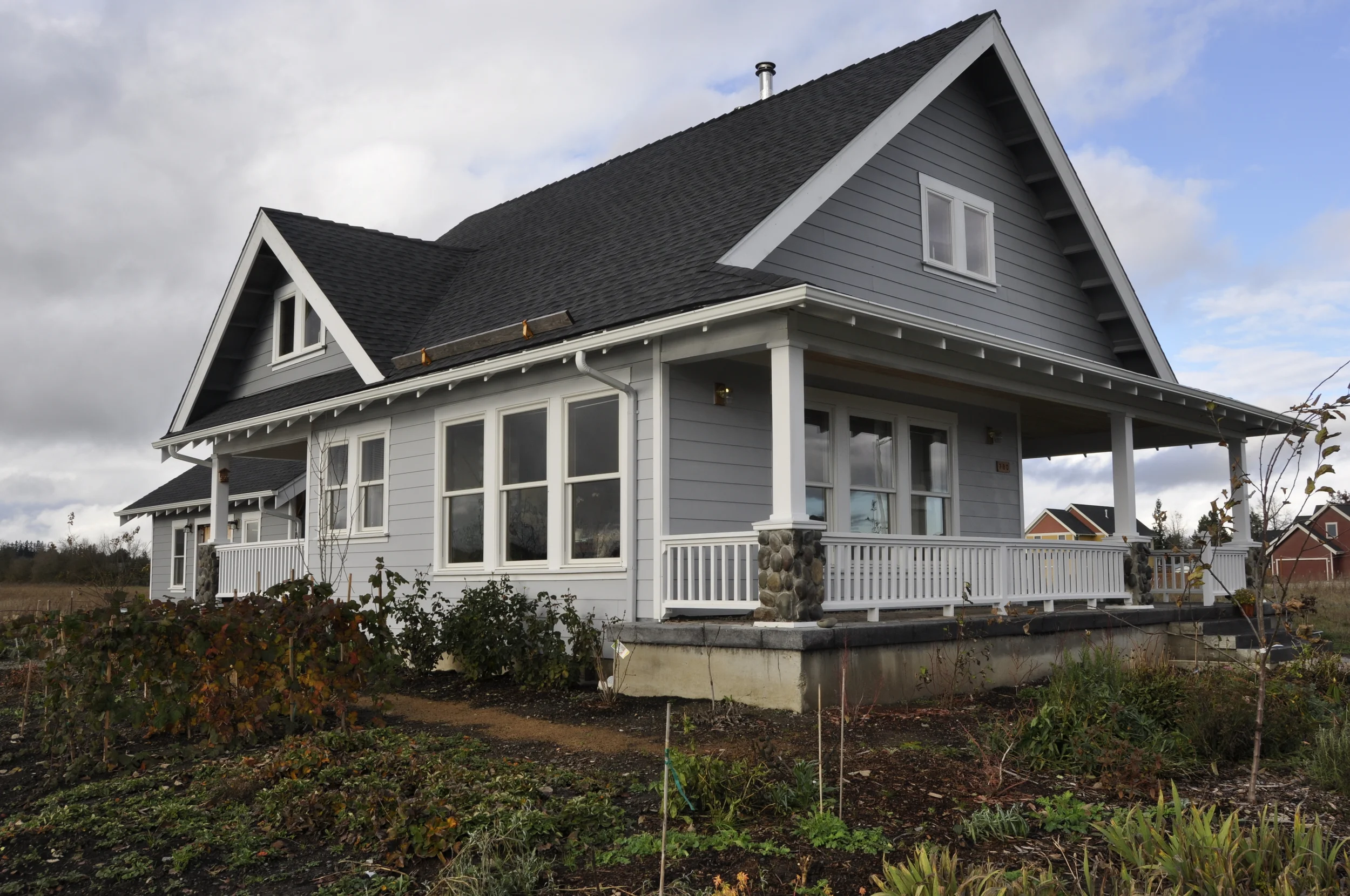 The house shortly after completion. Trees, berry bushes, roses and flowers of all kinds now surround the cottage.