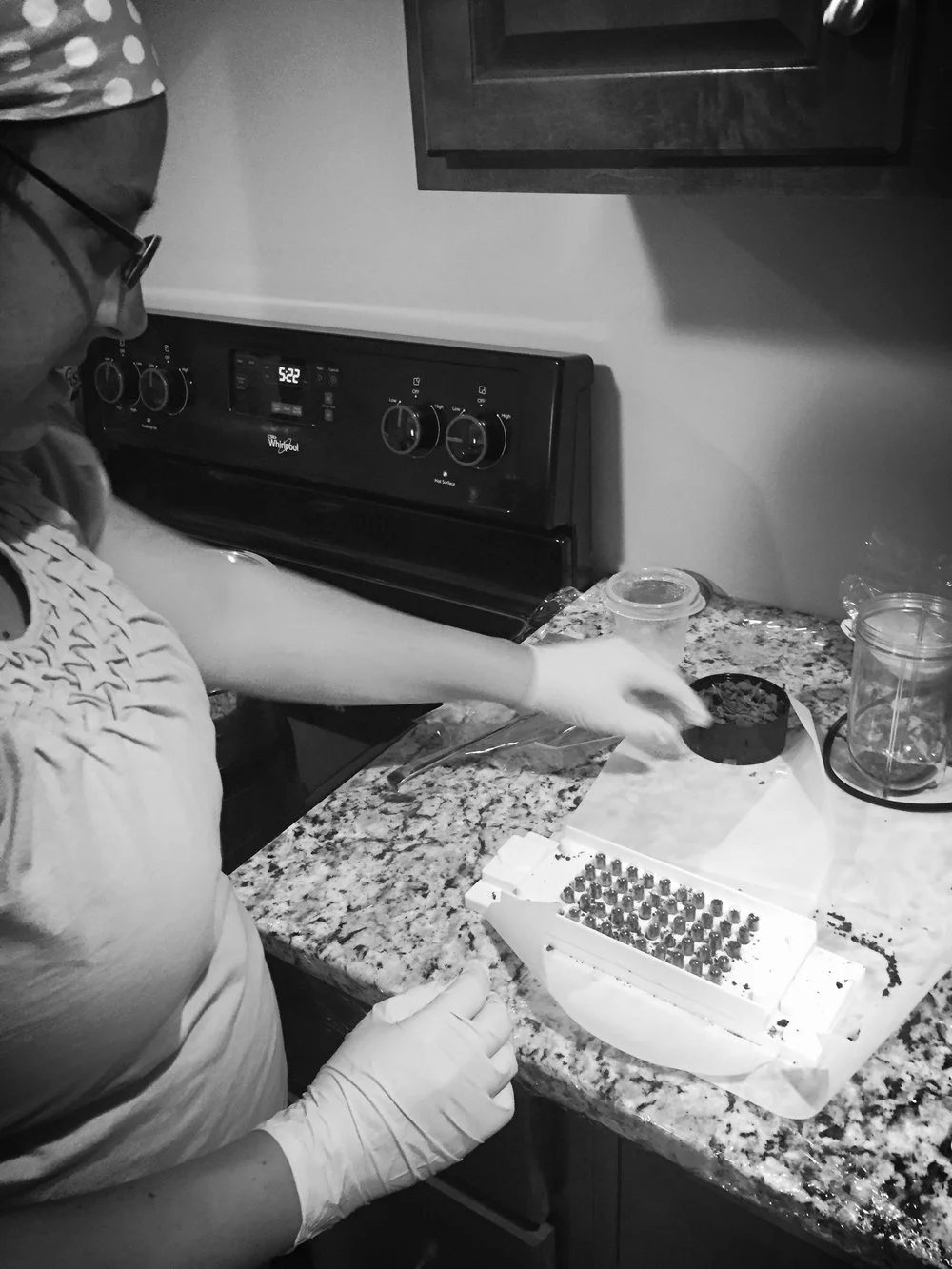 woman wearing gloves and encapsulating dried placenta into pills lexington ky