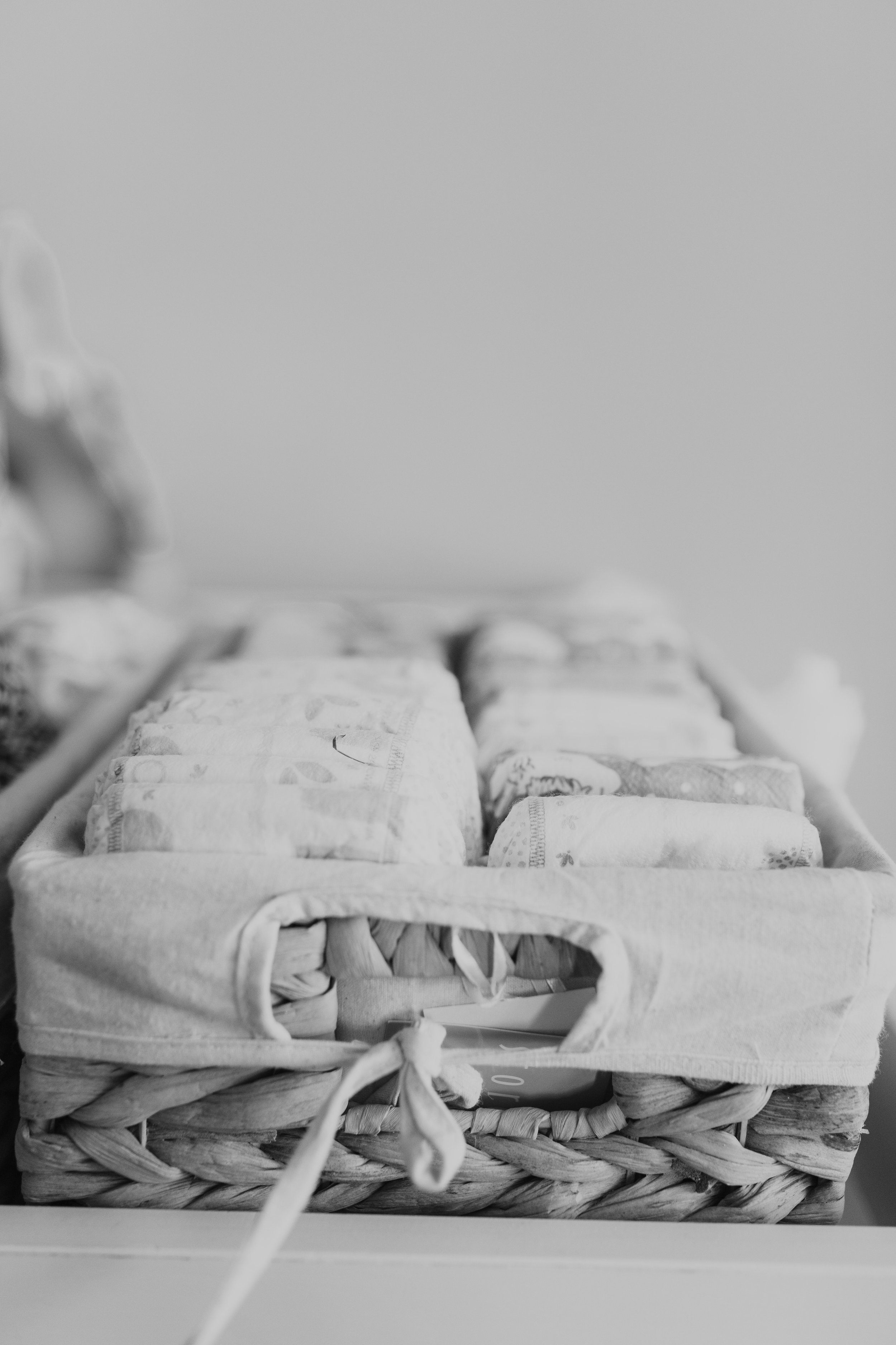 black and white image of diapers in a wicker bin