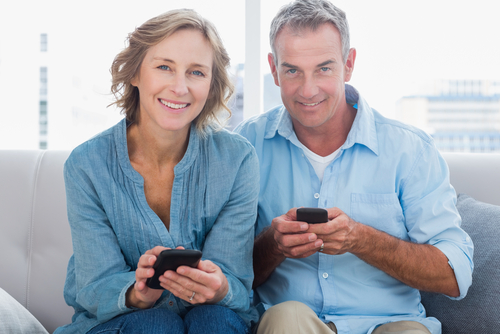 happy couple using phones.jpg