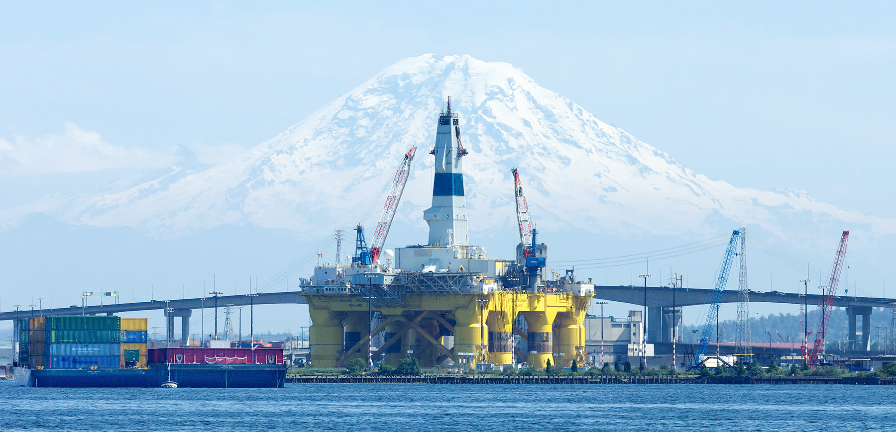 Shell Oil's controversial Arctic oil drilling rig, the Polar Pioneer, parked in the port of Seattle. Behind it is Mt. Rainier.