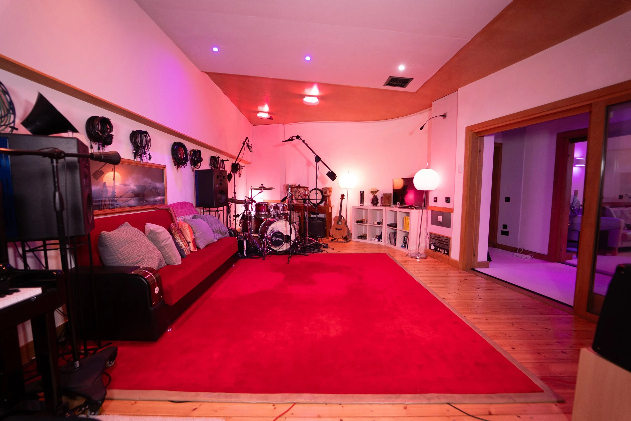 Room to breathe. Space to create.

Deep red carpet, warm timber and soft lighting set the mood in Studio 1’s spacious, acoustically treated live room. Settle in, play together and capture your sound through our SSL console and exceptional analogue ou