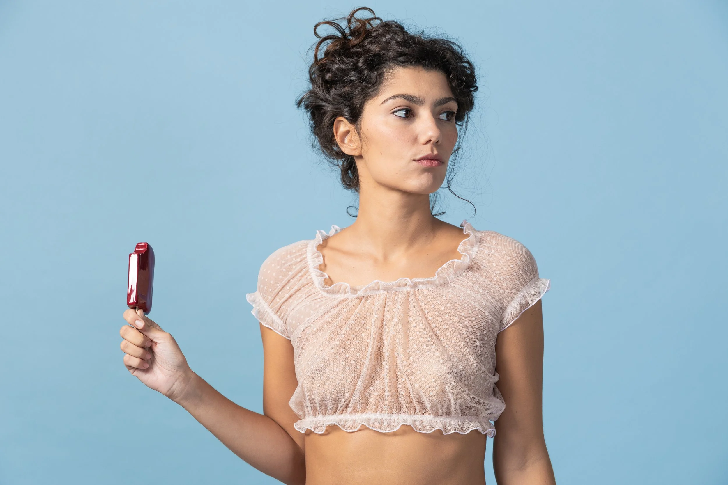 Close-up of Colette sheer light pink polka dot tulle crop top with ruffled edges, handmade by Voilà le Vélo.