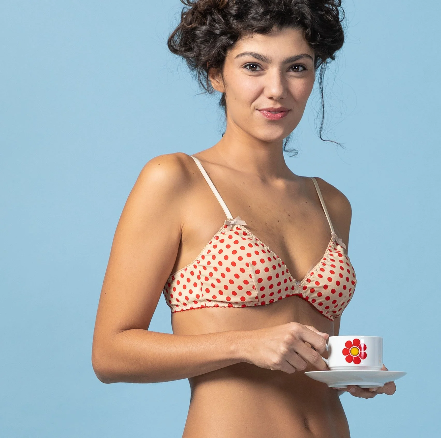 Close-up of the triangle bralette in red and beige silk with ivory lace edging.