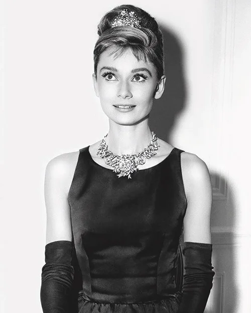 Audrey Hepburn posing in the Schlumberger Ribbon Necklace set with the Tiffany Diamond.