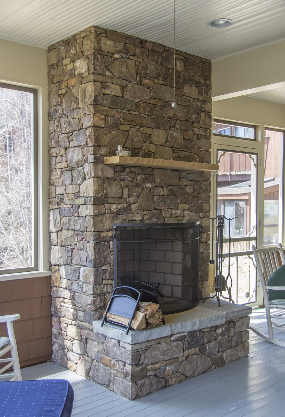 New stone fireplace in screened porch
