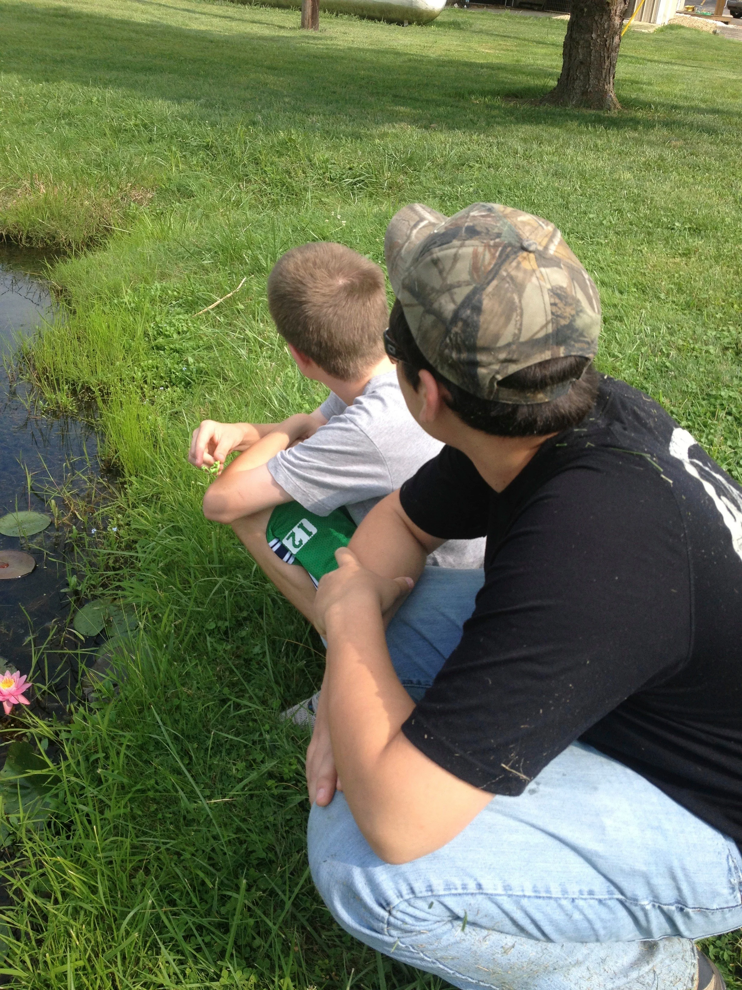 Adrian and Clay after taking a walk around the pond. This was the day that Adrian only wanted to see Clayton so we had to go get him off of the mower. Moments like this are what this job is all about!