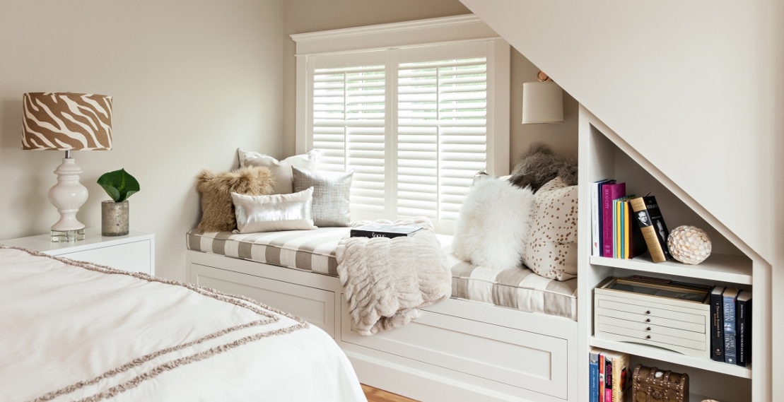 A faux fur throw and stacks of pillows make this space so inviting; from one of our interior design projects on Cape Cod.