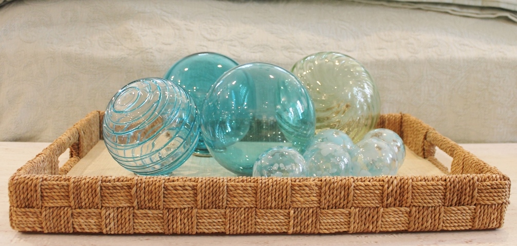 At Welch Company: A collection of glass spheres in a variety of beachy blues arranged in a jute-covered tray; an effortless way to add an impact to any room. 