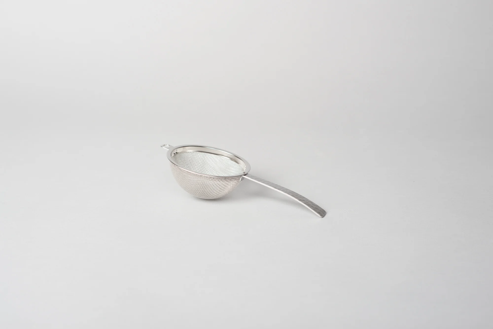 native&co-hammered-tea-strainer-and-saucer