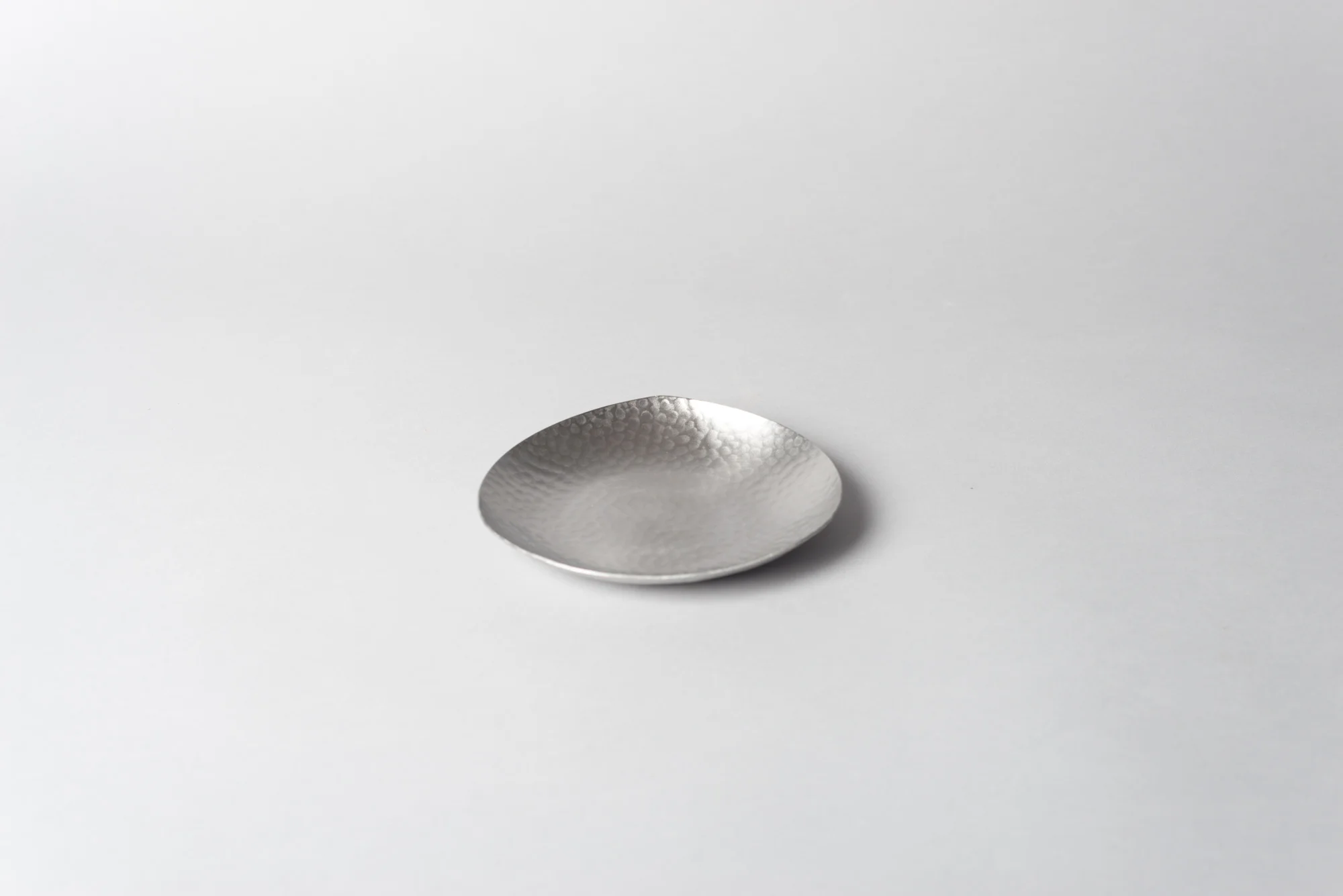 native&co-hammered-tea-strainer-and-saucer